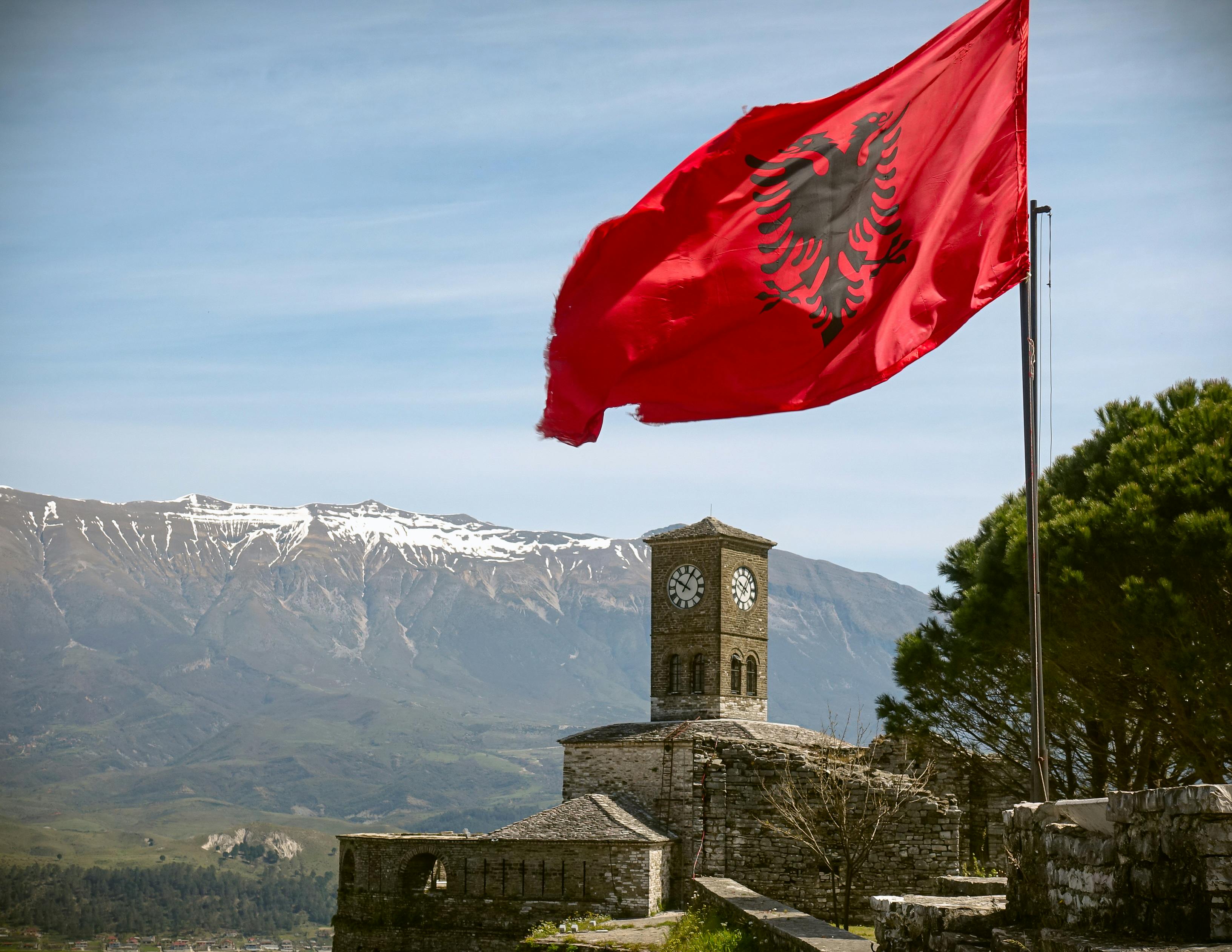 View of the Albanian flag and the Gjirokaster Fortress. Credit: Oscar M via Pexels.